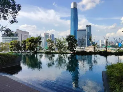 a large pond in a city with tall buildings at Central KL Retreat MyTown Ikea KLCC TRX Mall MRT in Kuala Lumpur
