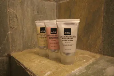 a group of three bottles of moisturizers on a counter at de King Hotel KLCC in Kuala Lumpur