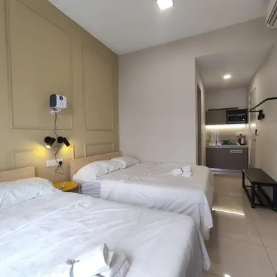 a hotel room with three beds and a kitchen at TRION studio 4 PAX tenseven in Kuala Lumpur