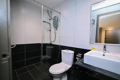 a bathroom with a shower and a toilet and a sink at Kingston Hotel 6 - Changkat, Bukit Bintang in Kuala Lumpur