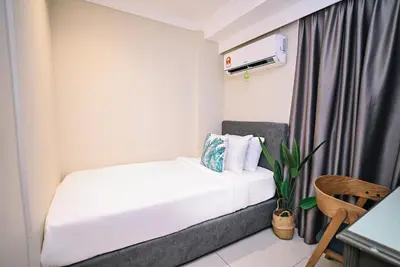 a small room with a bed and a chair at Kingston Hotel 6 - Changkat, Bukit Bintang in Kuala Lumpur