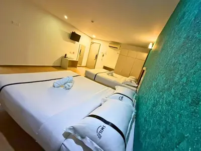 a hotel room with a bed with towels on it at Seeds Hotel Cheras Maluri in Kuala Lumpur