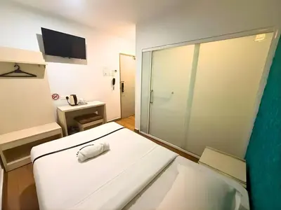 a white room with a sliding glass door with a sink at Seeds Hotel Cheras Maluri in Kuala Lumpur