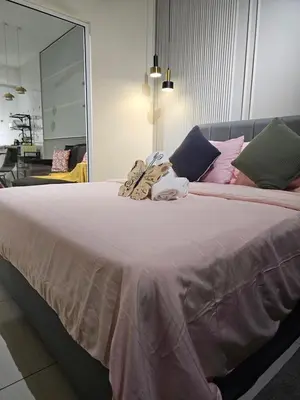 a large bed in a room with a large mirror at Anggun Arte Mont Kiara in Kuala Lumpur