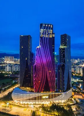 two tall buildings in a city at night at Anggun Arte Mont Kiara in Kuala Lumpur