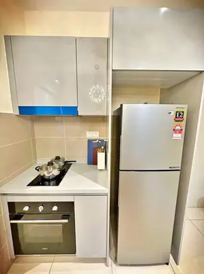 a small kitchen with a refrigerator and a stove at 2R2B*1-6+1 Pax*KL City*10mins-KLCC in Kuala Lumpur