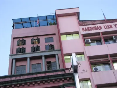 a pink building with the words benjamin franklin hall tower at Oasis Guest House in Kuala Lumpur