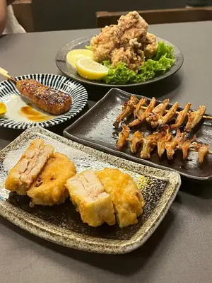 a table with plates of food on a table at The Mesui Hotel Bukit Bintang in Kuala Lumpur