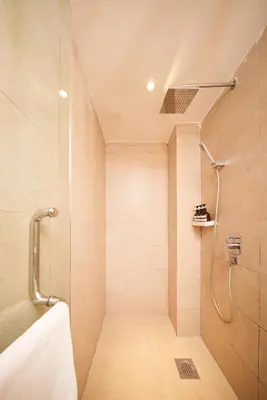a bathroom with a shower with a shower curtain at The Mesui Hotel Bukit Bintang in Kuala Lumpur