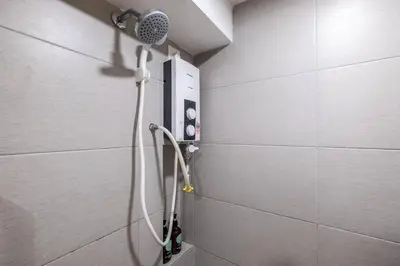 a shower in a bathroom with a shower head at Duplex Industrial Loft 5pax above Eko Cheras Mall in Kuala Lumpur