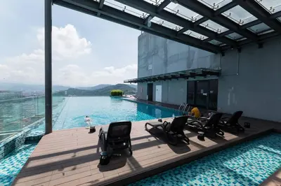 a swimming pool with chairs on a deck with a view at Duplex Industrial Loft 5pax above Eko Cheras Mall in Kuala Lumpur