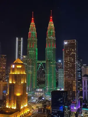 a group of tall buildings lit up at night at Leaves @ Legasi KLCC View, Kg Baru KL in Kuala Lumpur
