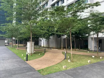 a park with trees in front of a building at Leaves @ Legasi KLCC View, Kg Baru KL in Kuala Lumpur