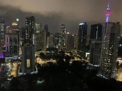 a view of a city at night with the tokyo tower at Leaves @ Legasi KLCC View, Kg Baru KL in Kuala Lumpur