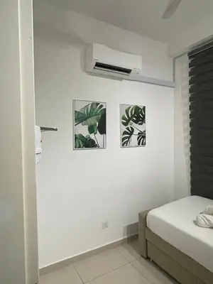 a bedroom with three pictures of plants on the wall at Leaves @ Legasi KLCC View, Kg Baru KL in Kuala Lumpur