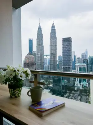 a view of a city skyline from a window at Leaves @ Legasi KLCC View, Kg Baru KL in Kuala Lumpur