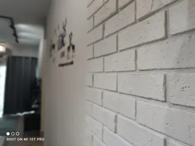a white brick wall next to a wall at HaNi Homestay KL in Kuala Lumpur