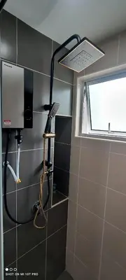 a small bathroom with a shower with a window at HaNi Homestay KL in Kuala Lumpur