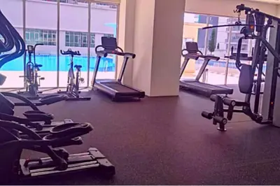 a gym with several treadmills and exercise bikes at HaNi Homestay KL in Kuala Lumpur