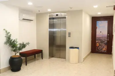 a elevator in a lobby with a potted plant at Hotel Seri Putra in Kuala Lumpur