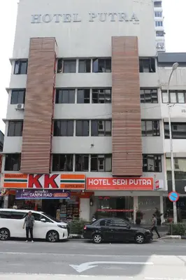 a hotel with cars parked in front of it at Hotel Seri Putra in Kuala Lumpur