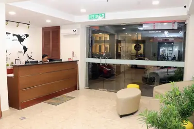 a man sitting at the reception desk of a store at Hotel Seri Putra in Kuala Lumpur