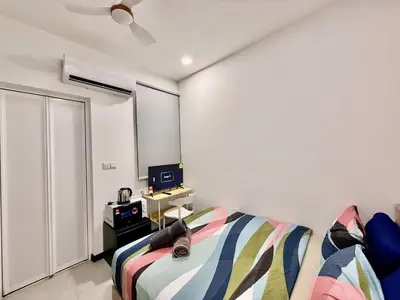 a bedroom with a bed and a television in it at Couple Suite at Neu Suites near Gleneagles in Kuala Lumpur