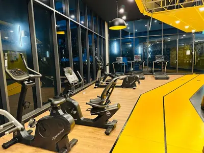a gym with a row of exercise bikes and treadmills at Couple Suite at Neu Suites near Gleneagles in Kuala Lumpur