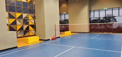 a tennis court with a net in a room at Trion KL in Kuala Lumpur