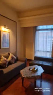 a living room with a couch and a coffee table at Regal Servies Suites at Times Square KL in Kuala Lumpur