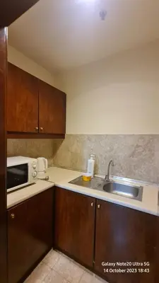 a kitchen with a sink and a microwave at Regal Servies Suites at Times Square KL in Kuala Lumpur