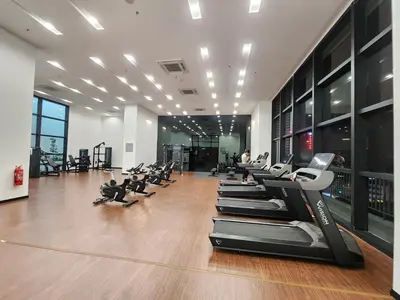 a gym with rows of exercise equipment on the floor at Chambers Suites KLCC Serviced Apartment in Kuala Lumpur