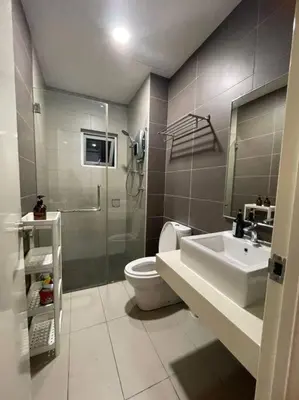 a bathroom with a toilet and a sink at Elisa Sentrio Pandan Suites in Kuala Lumpur