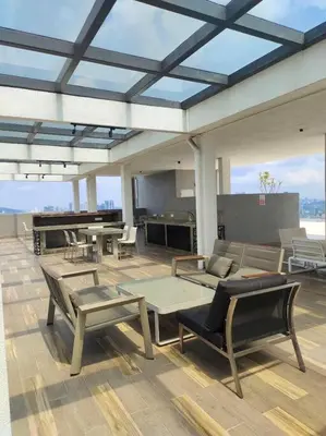 a patio with chairs and tables on a roof at Elisa Sentrio Pandan Suites in Kuala Lumpur