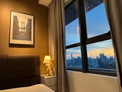 a bedroom with a window with a view of a city at FHS Homestay @ Arte Plus Jalan Ampang T3-33A-07 in Kuala Lumpur