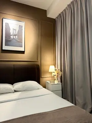 a bedroom with a bed and a window with curtains at FHS Homestay @ Arte Plus Jalan Ampang T3-33A-07 in Kuala Lumpur