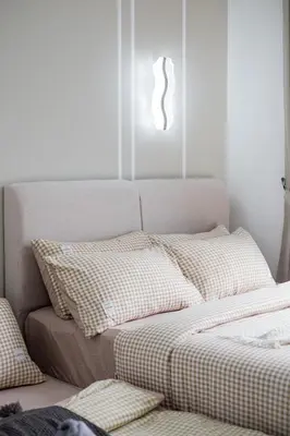 a bed with checkered sheets in a room at M Vertica KL Residence Tower E by Feel Home in Kuala Lumpur