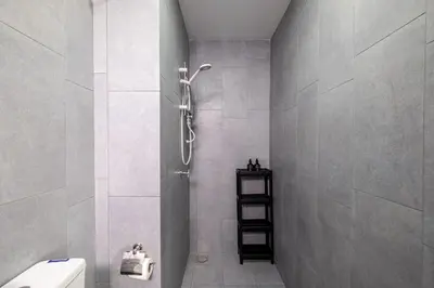 a bathroom with a shower with a toilet and a shelf at M Vertica KL Residence Tower E by Feel Home in Kuala Lumpur