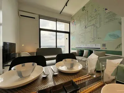 a dining room with a table with dishes on it at Nana'S at EST Bangsar KL Sentral Gem Loft in Kuala Lumpur