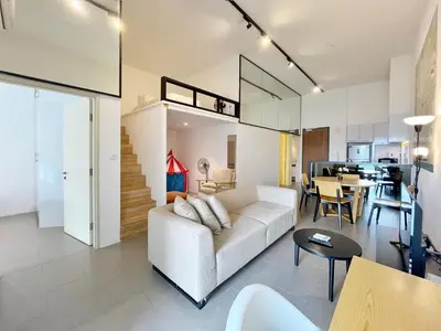 a living room with a white couch and a table at Nana'S at EST Bangsar KL Sentral Gem Loft in Kuala Lumpur