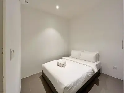 a bedroom with a bed with white sheets and pillows at Nana'S at EST Bangsar KL Sentral Gem Loft in Kuala Lumpur