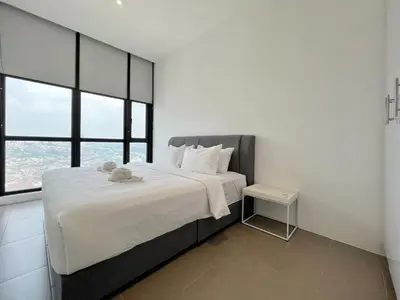 a bedroom with a large bed with a teddy bear on it at Nana'S at EST Bangsar KL Sentral Gem Loft in Kuala Lumpur