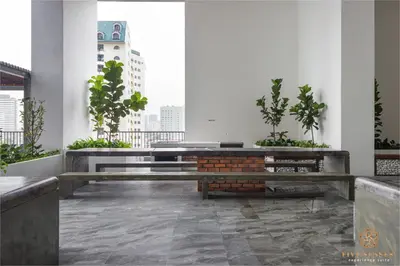 a room with benches and plants in a building at Chambers Signature Suites, Kuala Lumpur in Kuala Lumpur