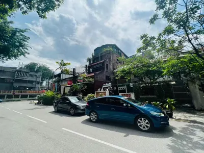 two cars parked on the side of a street at Hotel O I.villa Inn in Kuala Lumpur