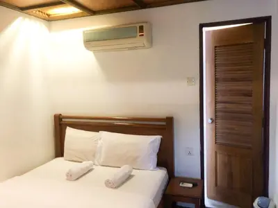 a bedroom with a bed with two pillows and a heater at Hotel O I.villa Inn in Kuala Lumpur