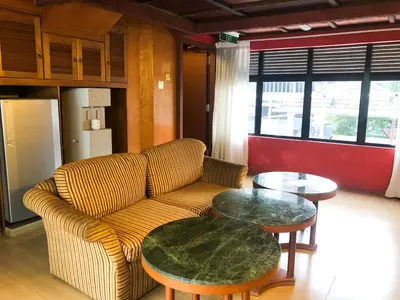 a living room with a couch and two tables at Hotel O I.villa Inn in Kuala Lumpur