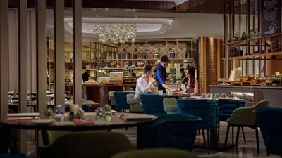 a group of people sitting at tables in a restaurant at ViiA Residence, Mid Valley KL in Kuala Lumpur