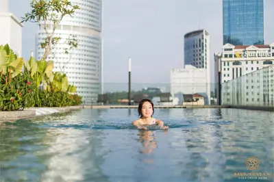 a woman in a swimming pool in a city at Quill City Residences KLCC, Five Senses in Kuala Lumpur