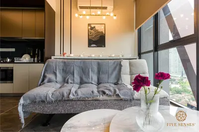 a living room with a couch and a table at Scarletz Signature Suites, KLCC in Kuala Lumpur