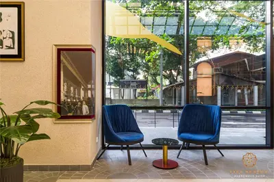 two blue chairs sitting in front of a building at Scarletz Signature Suites, KLCC in Kuala Lumpur